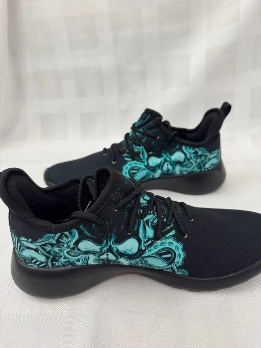 Unisex Black Lightweight Sneakers with Teal Skull Accent